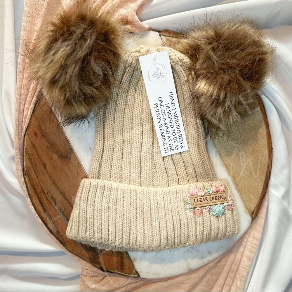 Custom embroidered knit beanie with pompoms
